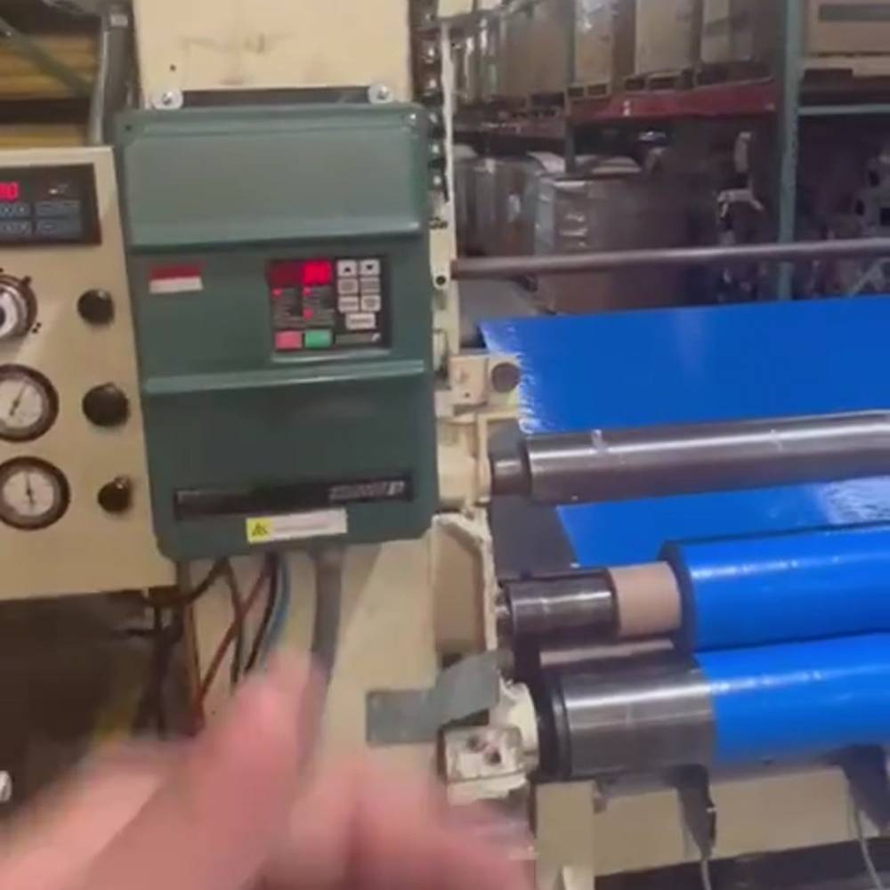 machine cutting blue roll of material